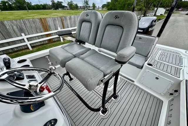 Slide: The Image of 2020 Sea Pro 248 Bay boat with dual gray seats and steering wheel. - 9