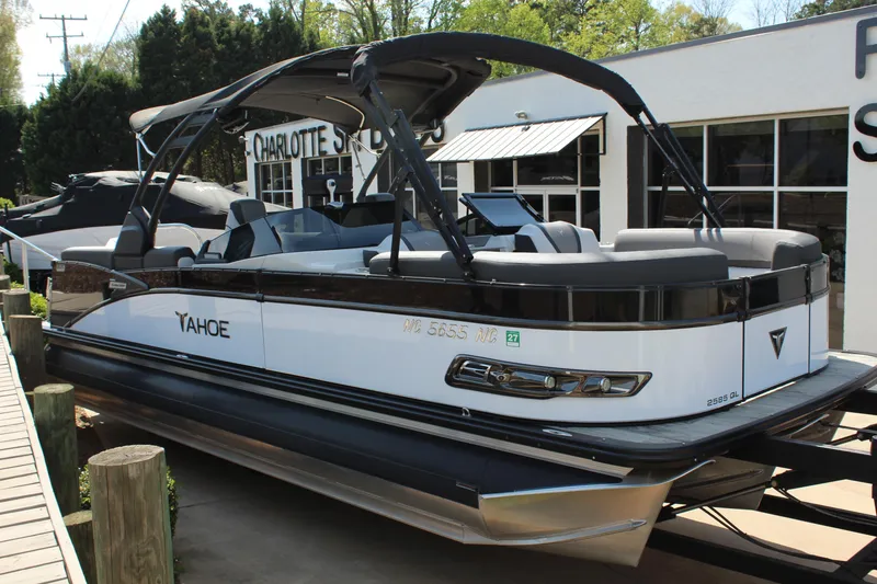 The Image of 2024 Tahoe Pontoon Cascade Quad Lounge Windshield boat displayed outdoors. - 1