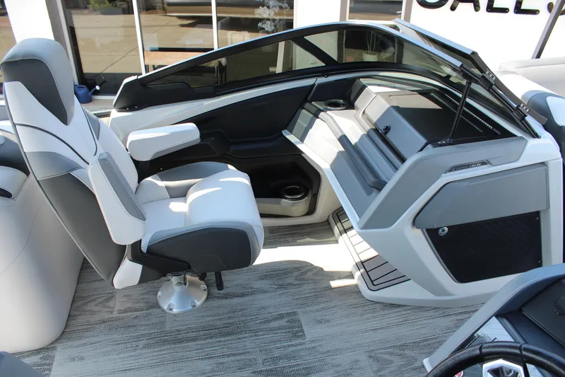 Slide: The Image of 2024 Tahoe Pontoon Cascade Quad Lounge Windshield interior with modern seating and sleek dashboard design. - 12