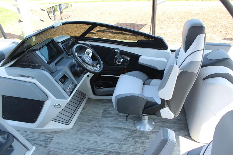 Slide: The Image of 2024 Tahoe Pontoon Cascade Quad Lounge Windshield interior with modern helm and seating. - 13