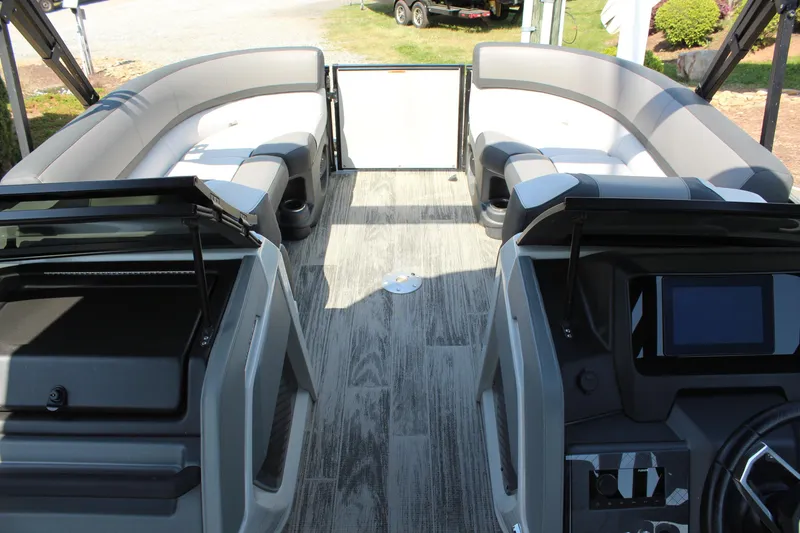 Slide: The Image of 2024 Tahoe Pontoon Cascade Quad Lounge Windshield interior with modern seating and dashboard. - 15