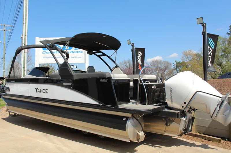 Slide: The Image of 2024 Tahoe Pontoon Cascade Quad Lounge Windshield boat displayed outdoors. - 6