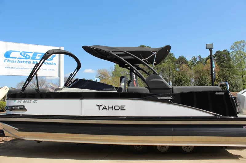 Slide: The Image of 2024 Tahoe Pontoon Cascade Quad Lounge Windshield boat displayed outdoors. - 7