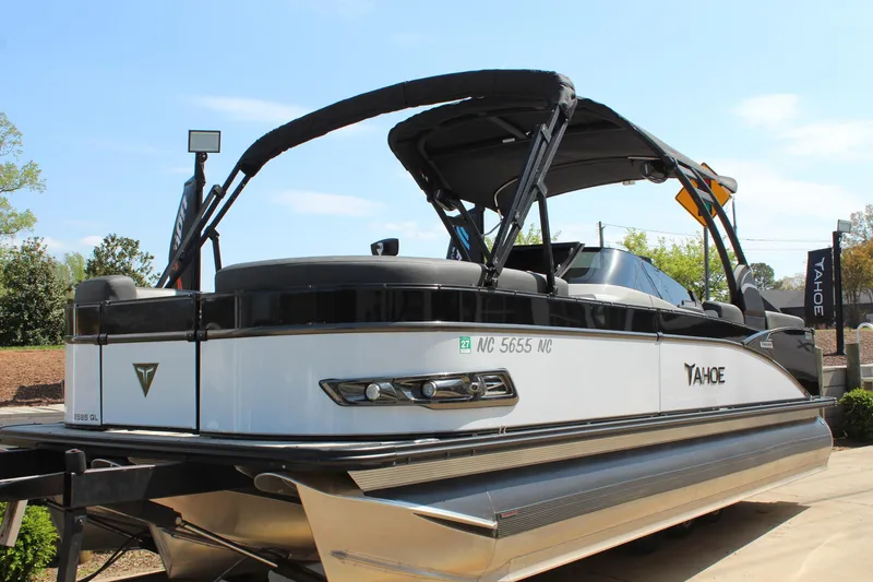 Slide: The Image of 2024 Tahoe Pontoon Cascade Quad Lounge Windshield boat, sleek design, docked outdoors. - 8
