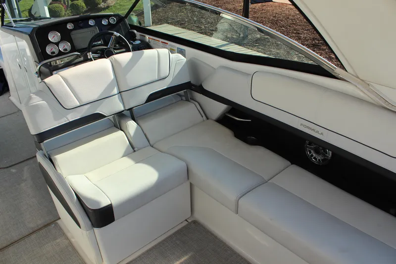 Slide: The Image of 2023 Formula 310 Bowrider I/O interior with luxurious white seating and modern dashboard. - 11