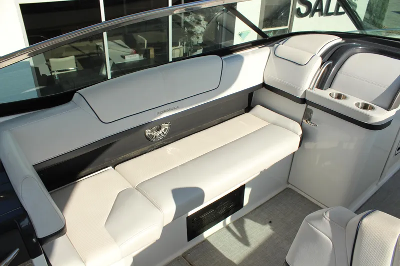 Slide: The Image of 2023 Formula 310 Bowrider I/O interior with white seating and cup holders. - 14