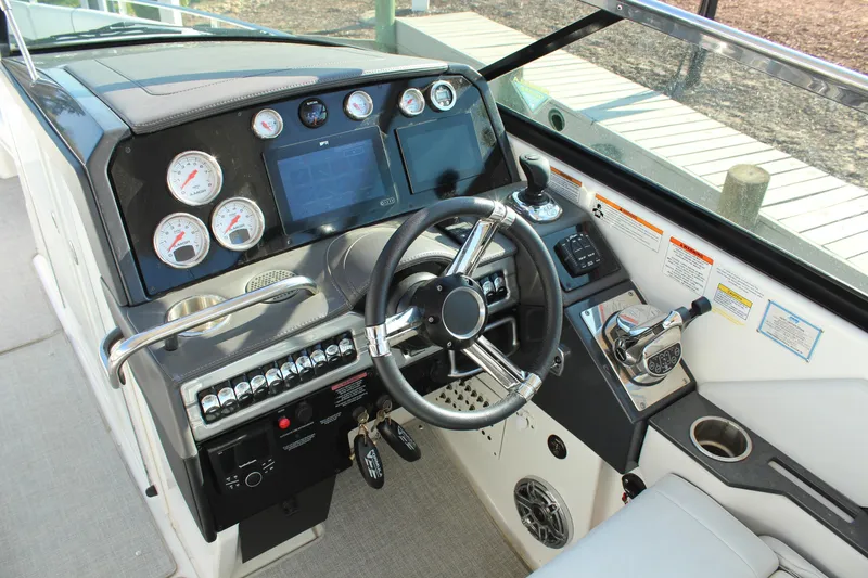 Slide: The Image of 2023 Formula 310 Bowrider I/O dashboard with steering wheel and control panel. - 18