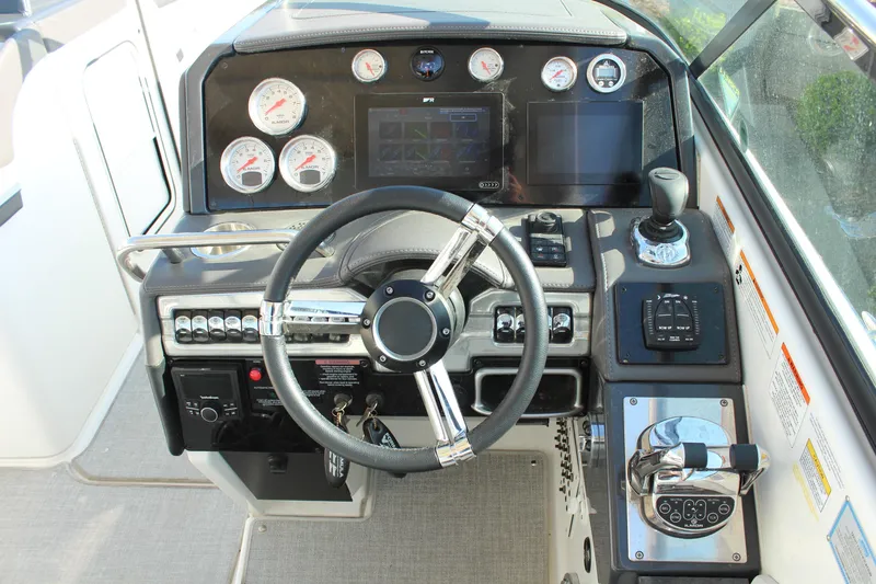 Slide: The Image of Dashboard of 2023 Formula 310 Bowrider I/O with steering wheel and control panels. - 19