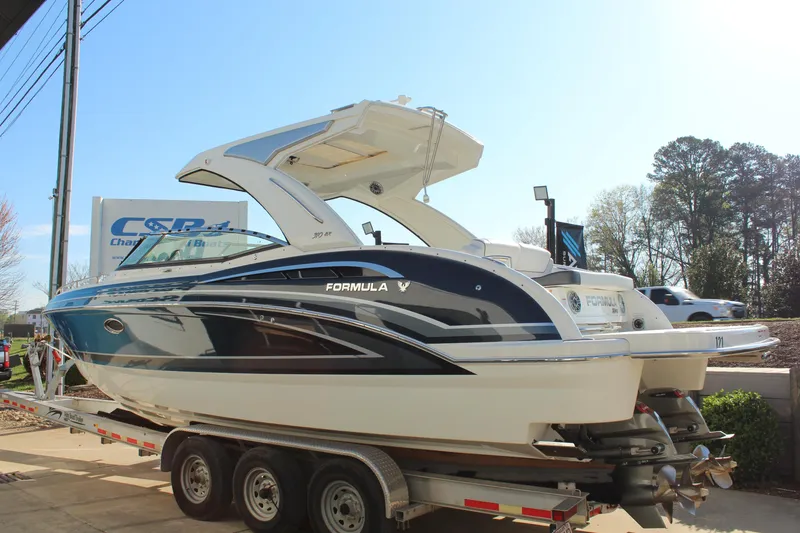 Slide: The Image of 2023 Formula 310 Bowrider I/O boat on trailer, displayed outdoors. - 4