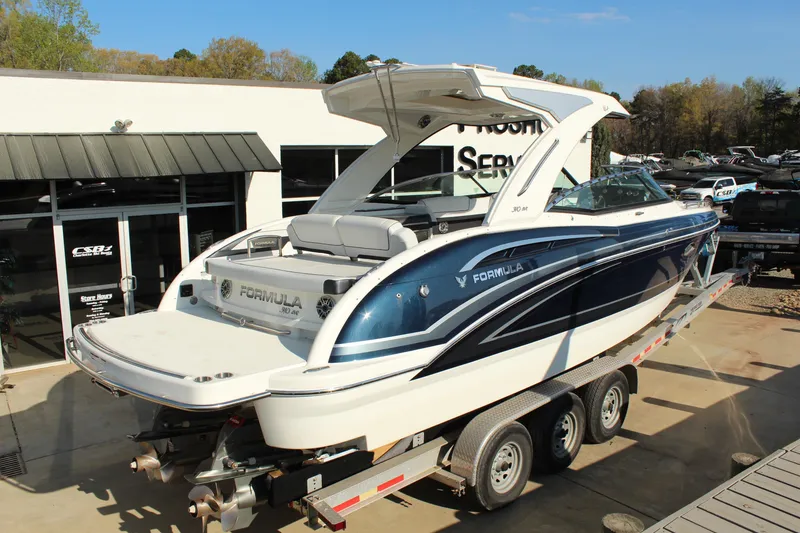 Slide: The Image of 2023 Formula 310 Bowrider I/O boat on trailer, displayed outdoors at dealership. - 6