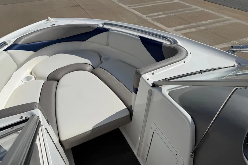 Slide: The Image of 2005 Yamaha Boats SX230 interior with cushioned seating and cup holders. - 11