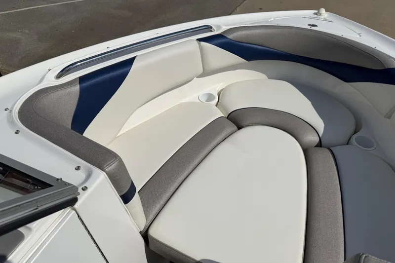 Slide: The Image of 2005 Yamaha Boats SX230 interior seating with white and gray upholstery. - 12