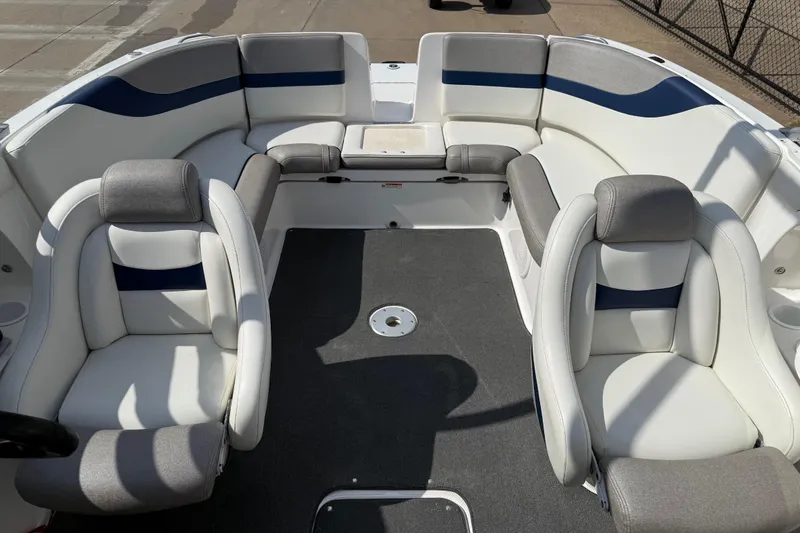 Slide: The Image of 2005 Yamaha Boats SX230 interior with white and gray seating, spacious layout. - 16