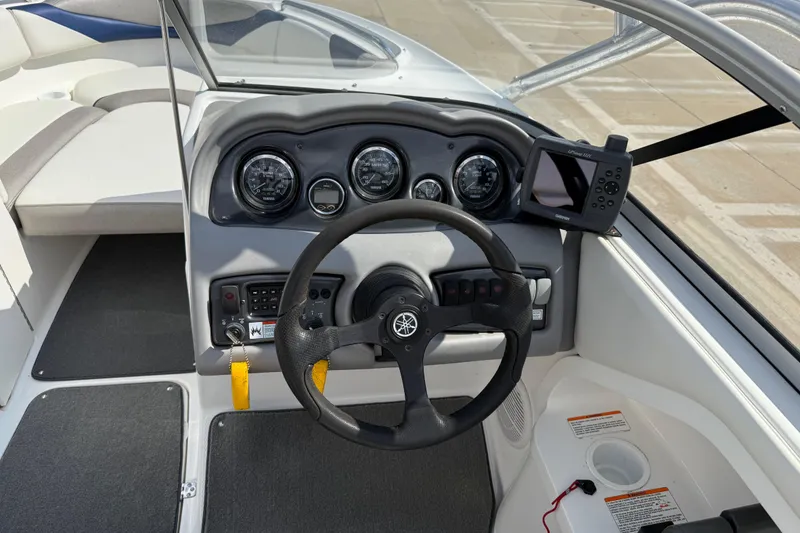 Slide: The Image of 2005 Yamaha Boats SX230 dashboard with steering wheel and navigation system. - 18