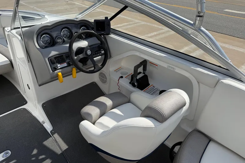 Slide: The Image of 2005 Yamaha Boats SX230 cockpit with steering wheel, gauges, and comfortable seating. - 19
