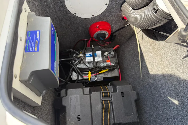 Slide: The Image of Battery compartment of a 2005 Yamaha Boats SX230, featuring wiring and components. - 26