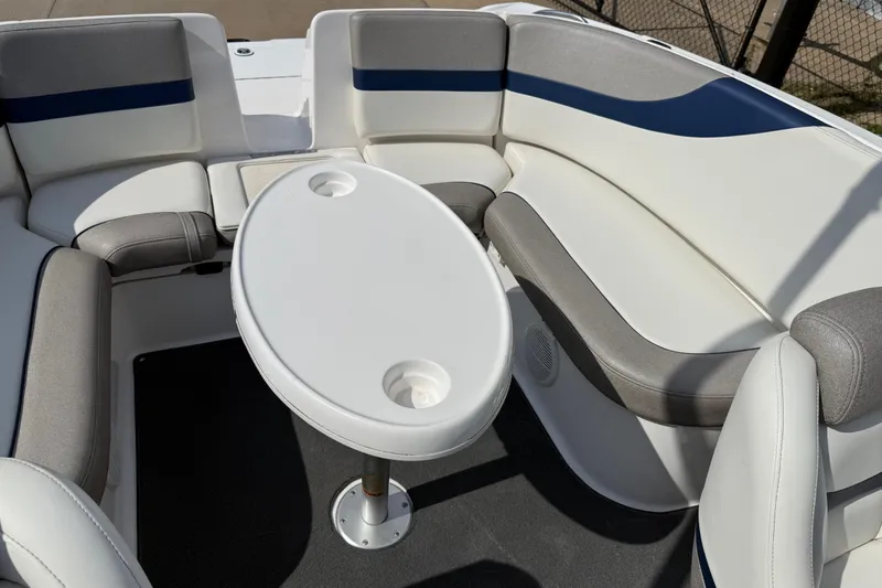 Slide: The Image of 2005 Yamaha Boats SX230 interior with cushioned seating and oval table. - 29