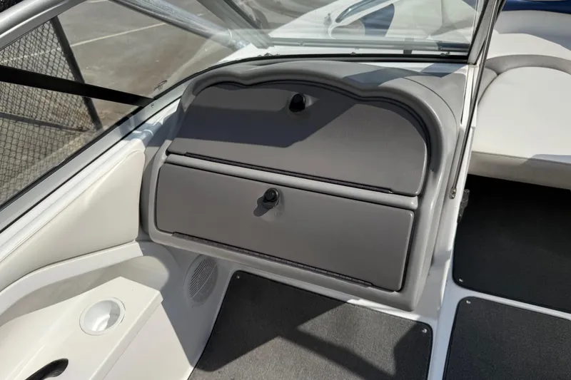 Slide: The Image of 2005 Yamaha Boats SX230 interior showing dashboard storage compartment and seating area. - 34