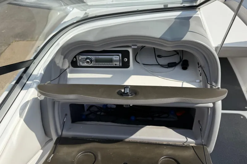 Slide: The Image of 2005 Yamaha Boats SX230 dashboard with stereo system and open glove compartment. - 35