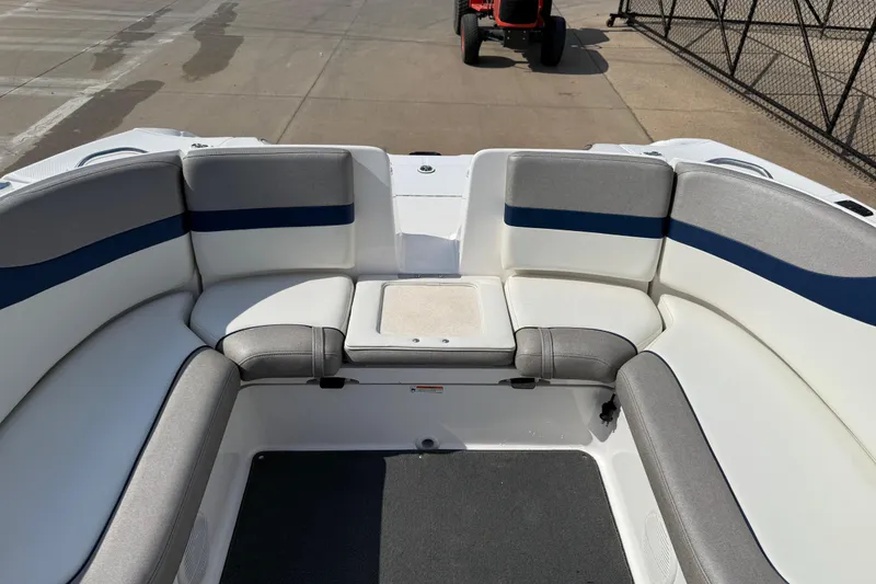 Slide: The Image of 2005 Yamaha Boats SX230 interior with gray and blue seating on a sunny day. - 42