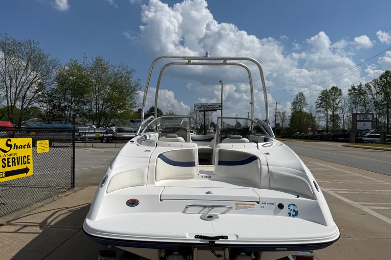 Slide: The Image of 2005 Yamaha Boats SX230 in parking lot, sunny day, blue sky, and clouds. - 6