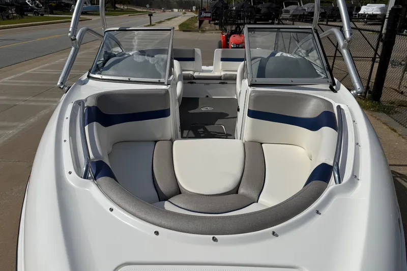 Slide: The Image of 2005 Yamaha Boats SX230 with spacious seating and sleek design, parked on a sunny street. - 8