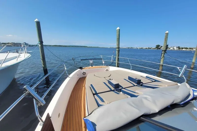 Slide: The Image of 2024 Hanover 387 yacht docked on a sunny day, featuring spacious deck and serene water view. - 6