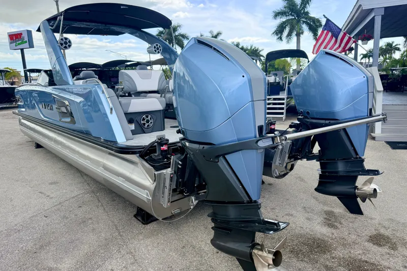 Slide: The Image of 2026 Avalon 2 pontoon boat with dual outboard motors, displayed outdoors. - 11
