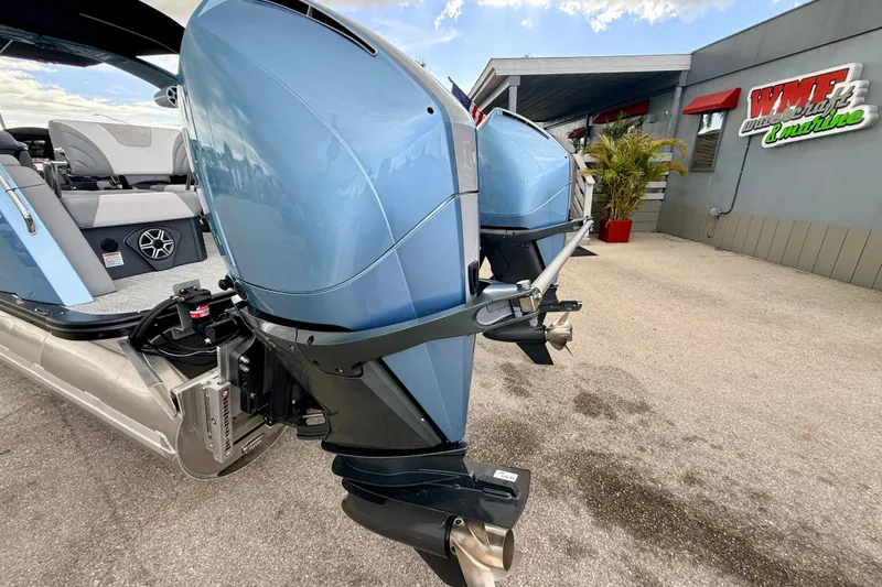 Slide: The Image of 2026 Avalon 2 boat with dual outboard motors at a marine dealership. - 14