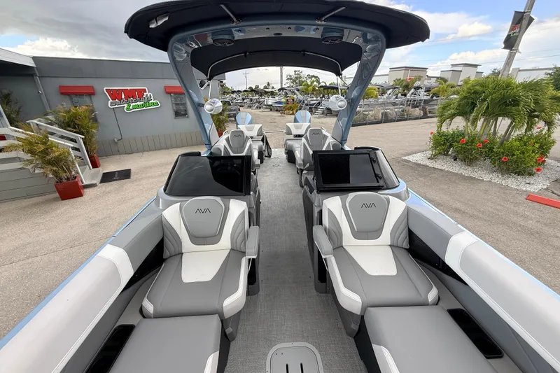 Slide: The Image of 2026 Avalon 2 boat interior with modern seating and sleek design at a marina. - 30
