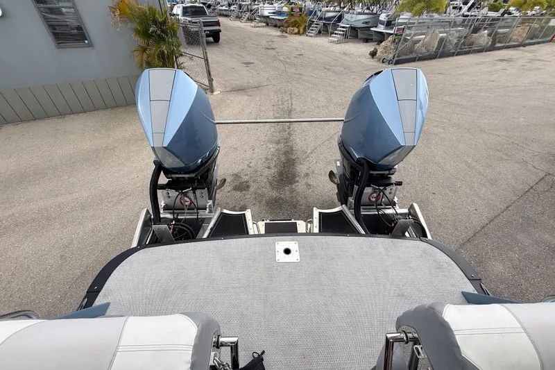 Slide: The Image of 2026 Avalon 2 boat with dual outboard motors in a marina setting. - 34