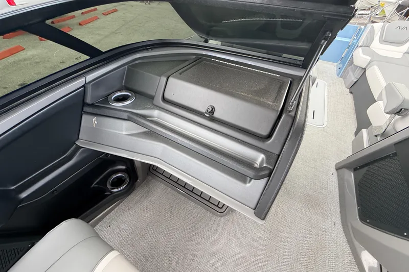 Slide: The Image of Interior of 2026 Avalon Model 2 boat with open storage compartment and cup holders. - 38