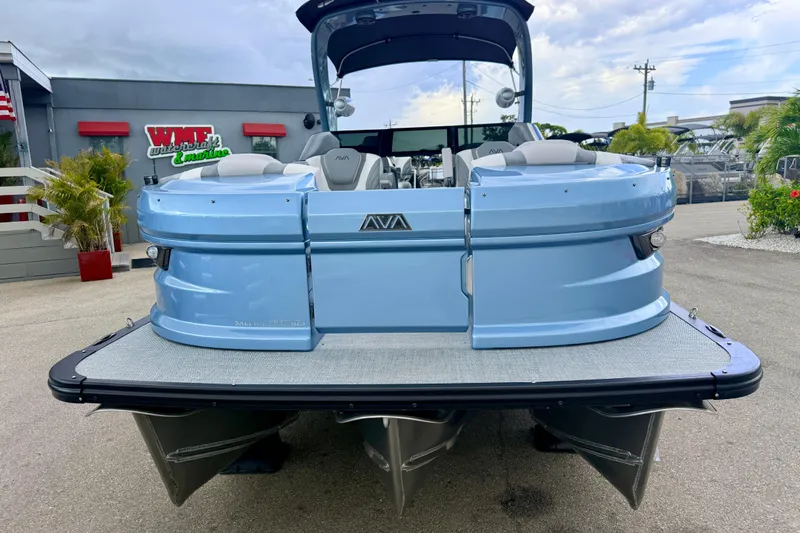 Slide: The Image of 2026 Avalon 2 pontoon boat in light blue, displayed at a dealership. - 4