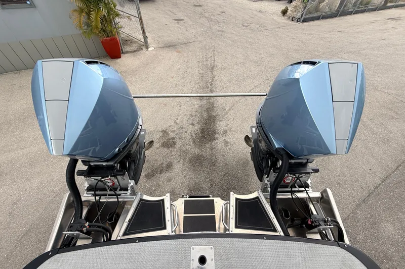 Slide: The Image of Twin outboard motors on a 2026 Avalon 2 boat, parked on concrete. - 43