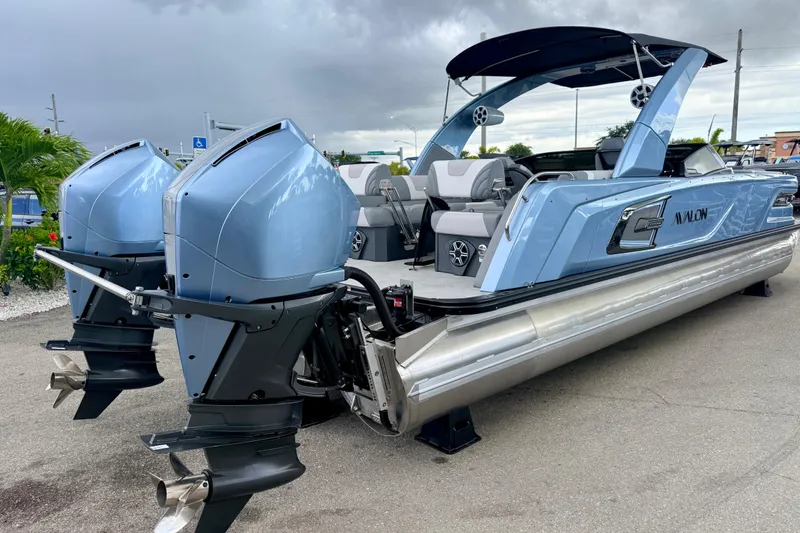 Slide: The Image of 2026 Avalon 2 pontoon boat with dual outboard motors, sleek design, and modern seating. - 7