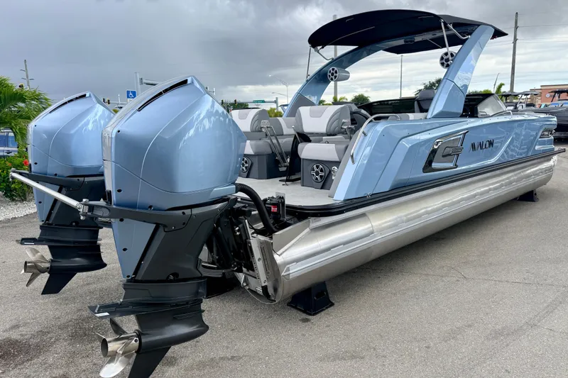 Slide: The Image of 2026 Avalon 2 pontoon boat with dual outboard motors, sleek design, and modern features. - 8