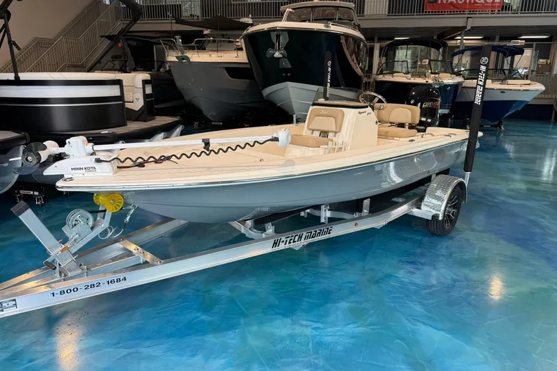 The Image of 2026 Scout 177 XSS boat on trailer in showroom, featuring Minn Kota motor. - 0