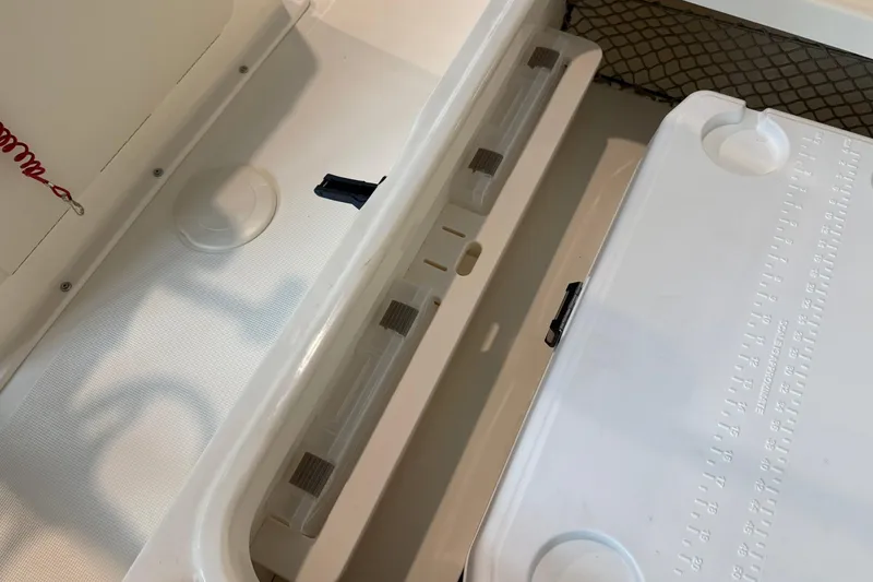 Slide: The Image of Interior view of 2026 Scout 177 XSS boat, featuring storage compartments and seating. - 12