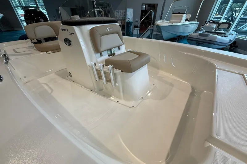 Slide: The Image of 2026 Scout 177 XSS boat interior with beige seating and rod holders. - 6