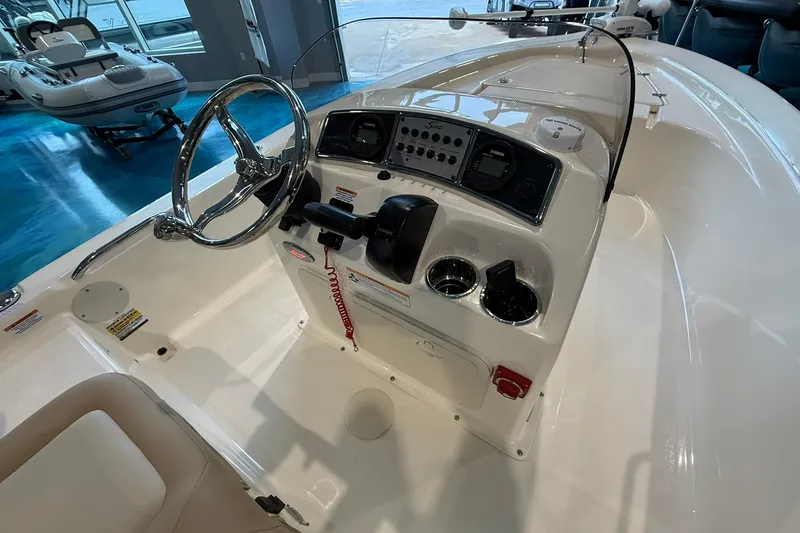 Slide: The Image of 2026 Scout 177 XSS boat dashboard with steering wheel and control panel. - 8