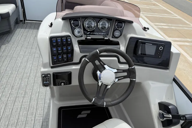 Slide: The Image of 2022 Starcraft SLS 3 boat dashboard with steering wheel and control panel. - 18
