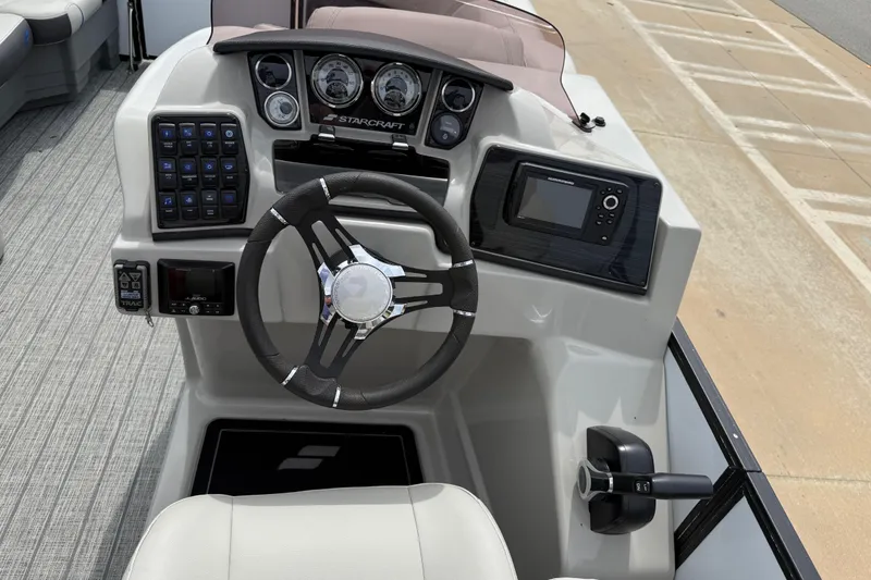 Slide: The Image of Cockpit of 2022 Starcraft SLS 3 boat with steering wheel and control panel. - 23