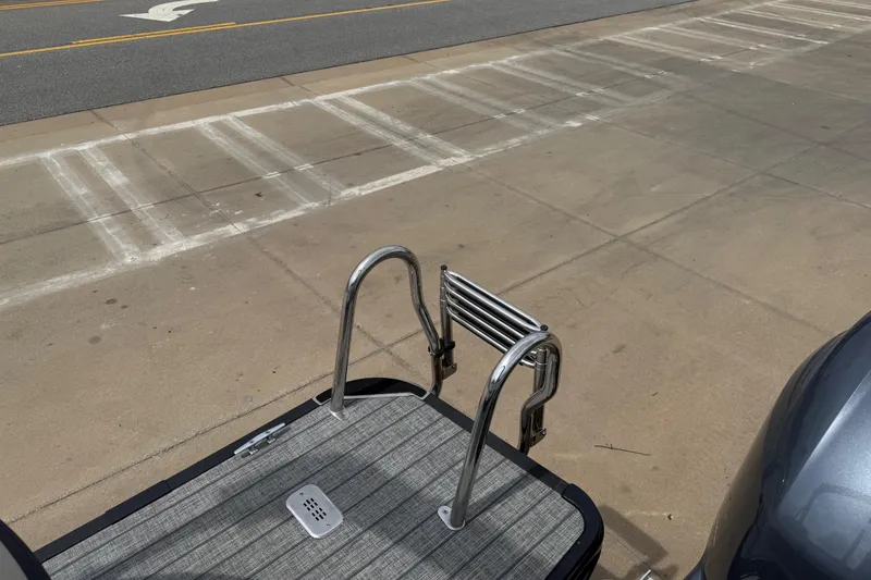 Slide: The Image of 2022 Starcraft SLS 3 boat ladder on dockside, featuring sleek metal rails. - 33