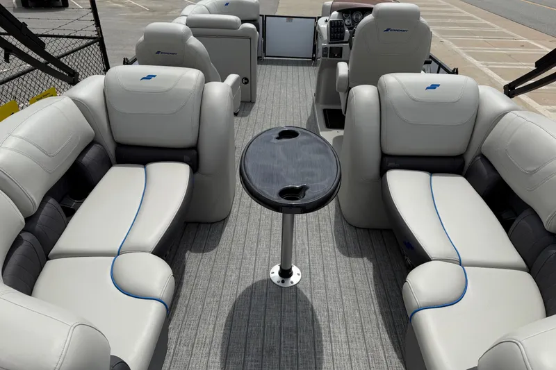 Slide: The Image of 2022 Starcraft SLS 3 pontoon boat interior with plush seating and central table. - 34