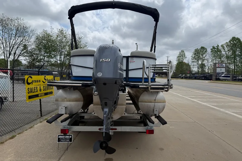 Slide: The Image of 2022 Starcraft SLS 3 pontoon boat with 150 HP engine on trailer at sales lot. - 6
