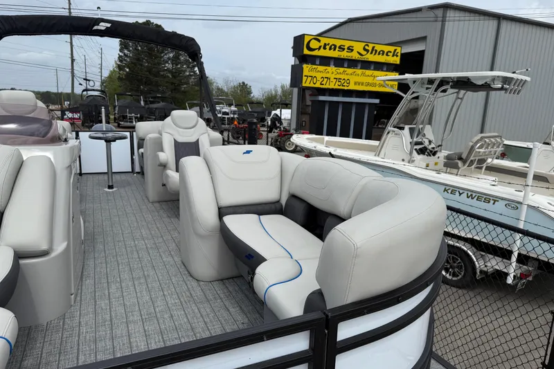 Slide: The Image of 2022 Starcraft SLS 3 pontoon boat with plush seating at a dealership. - 9