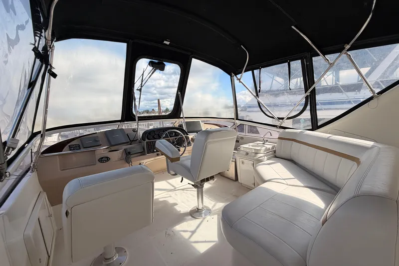 Slide: The Image of Interior of 2005 Carver 41 Cockpit Motor Yacht with helm and seating area. - 12