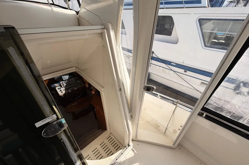 Slide: The Image of Interior view of 2005 Carver 41 Cockpit Motor Yacht, showing helm and cockpit area. - 14
