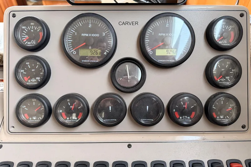 Slide: The Image of Dashboard of a 2005 Carver 41 Cockpit Motor Yacht with various gauges and dials. - 17