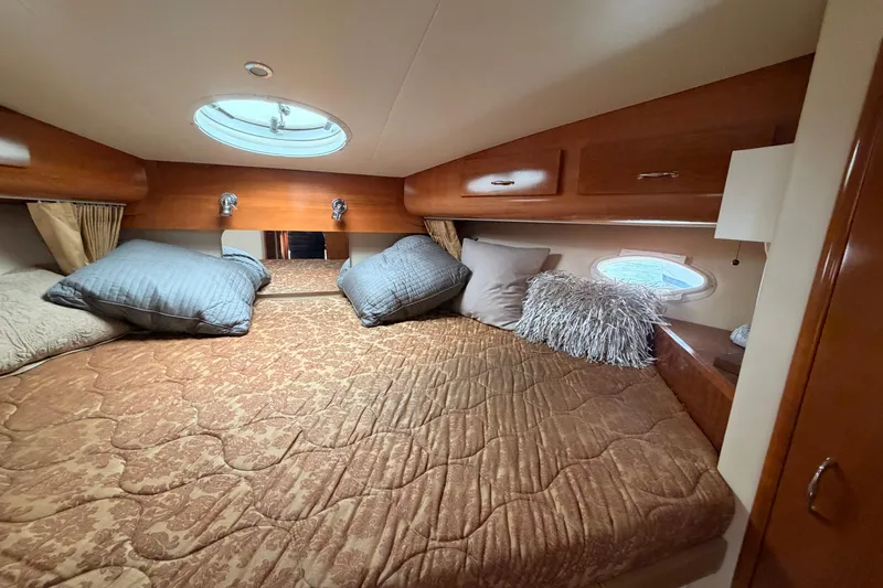 Slide: The Image of Luxurious cabin interior of 2005 Carver 41 Cockpit Motor Yacht with plush bedding. - 19